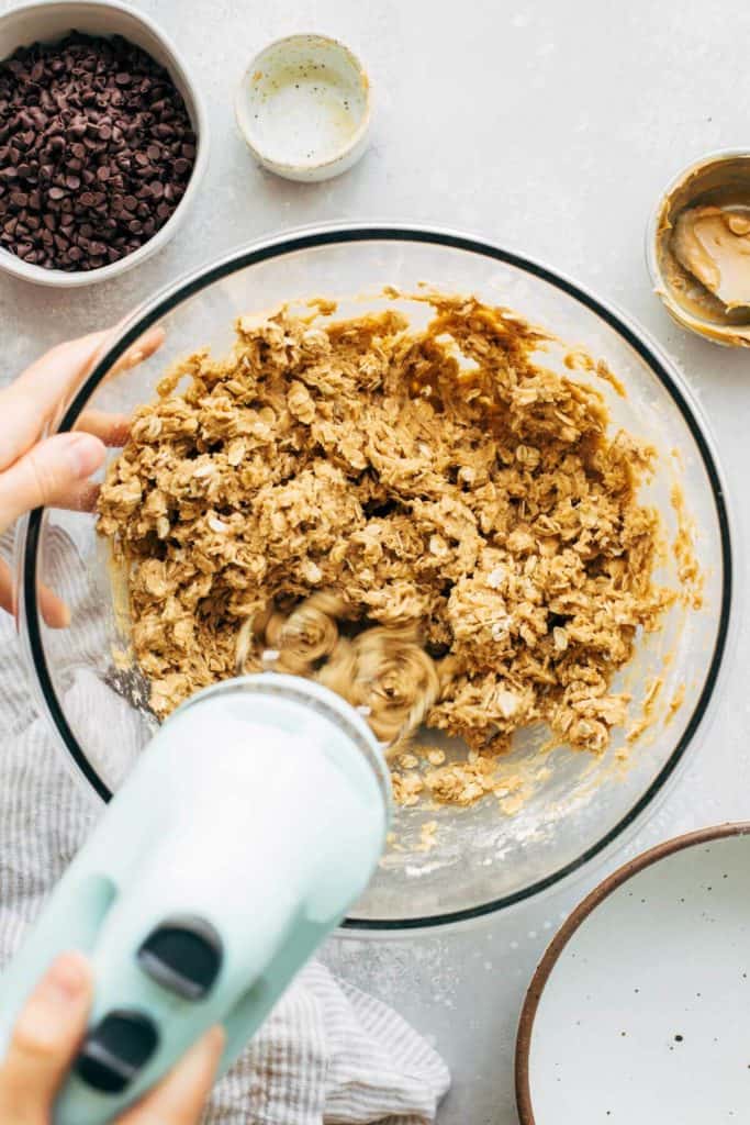 mixing peanut butter oatmeal cookie dough in a bowl