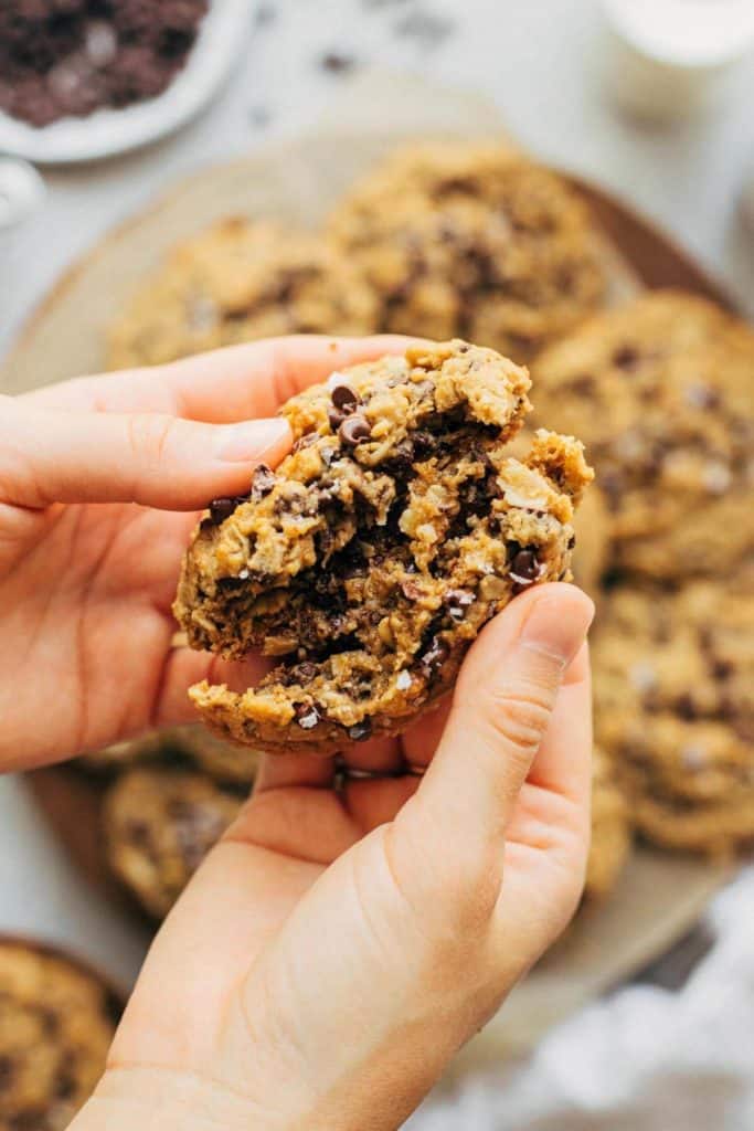 splitting a peanut butter oatmeal cookie in half