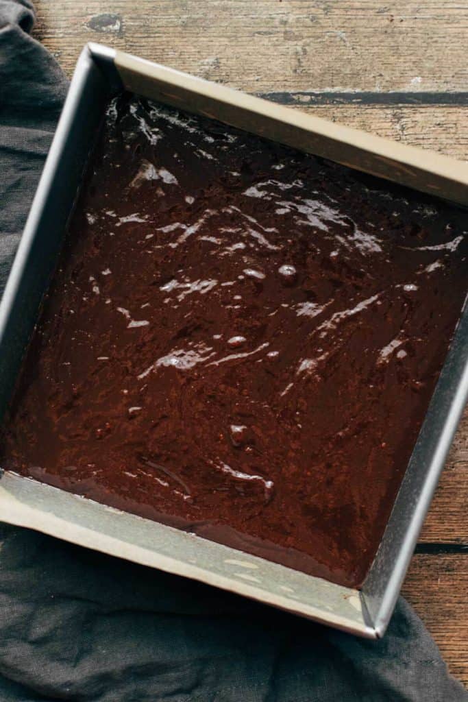 brownie batter poured into a square baking dish