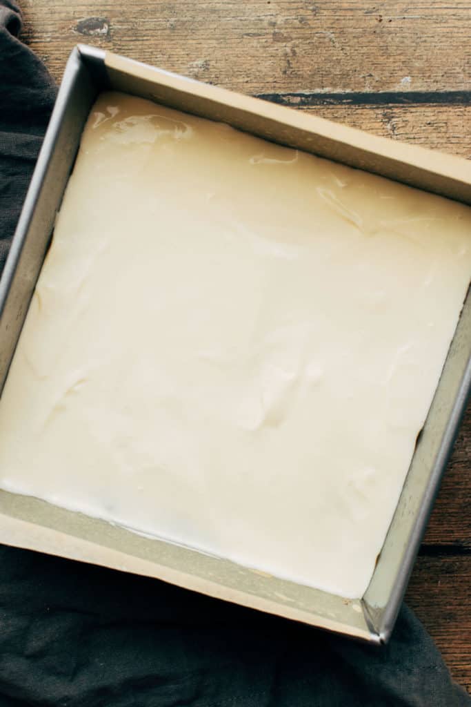 cheesecake batter poured into a square baking dish