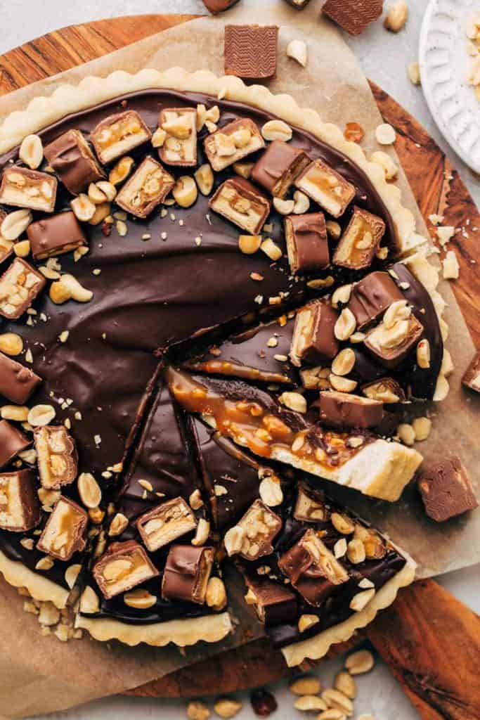 the top of a snickers tart with slices taken out