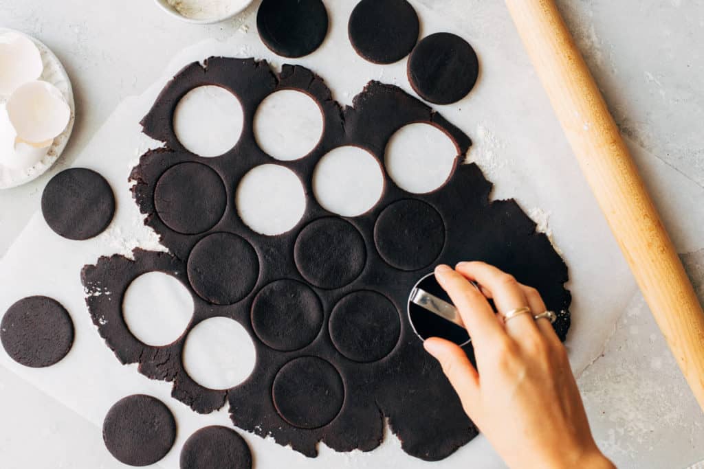 cutting circles out of rolled chocolate cookie dough