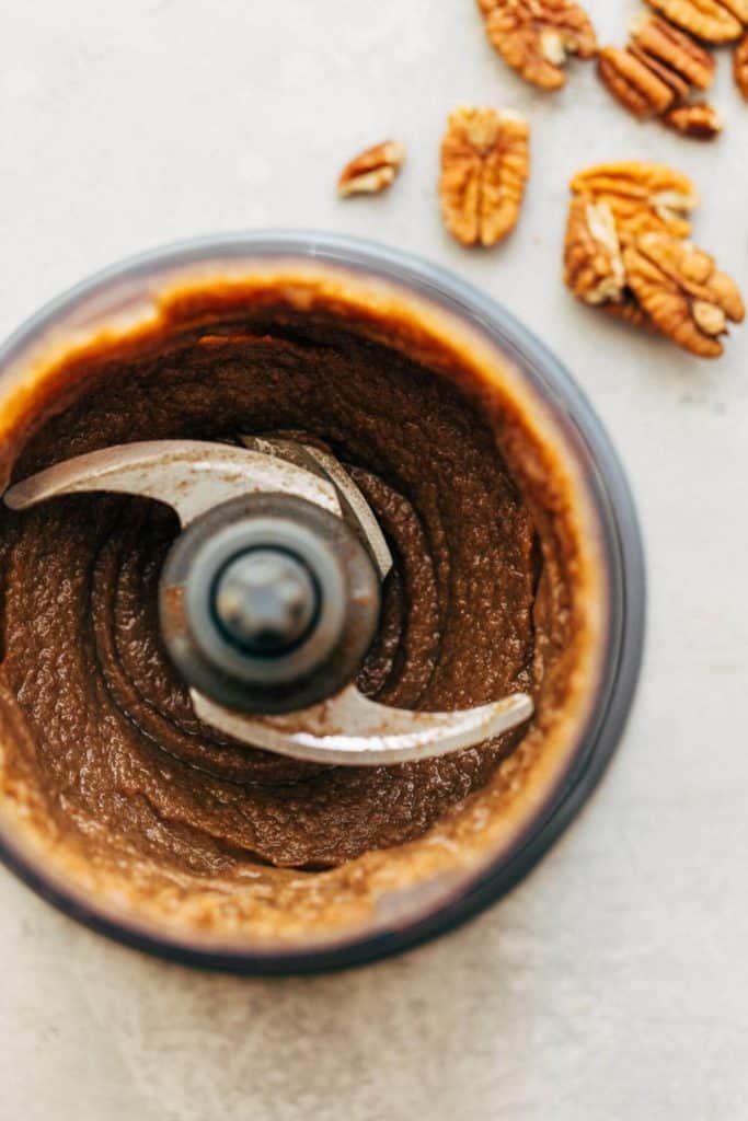 a food processor filled with maple pecan butter