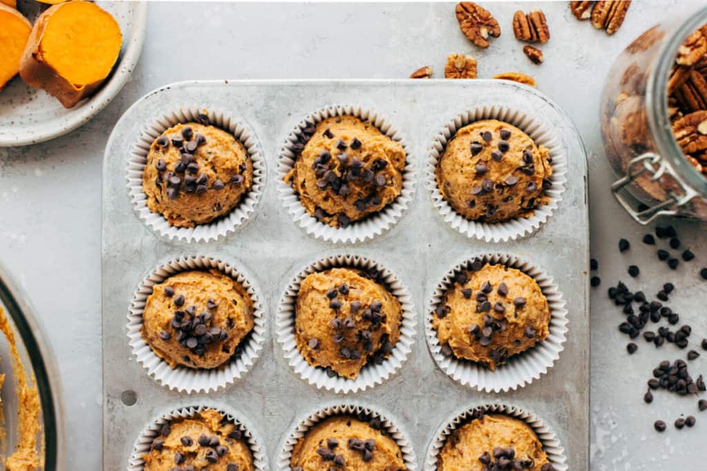 sweet potato muffin batter scooped into a cupcake tin