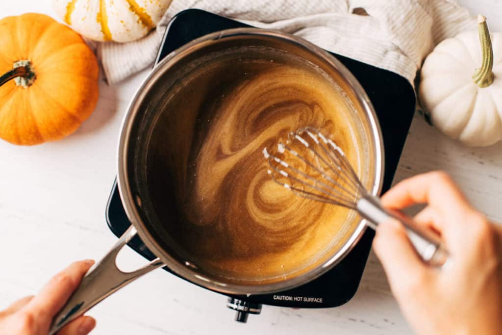 whisking melted butterscotch sauce in a saucepan