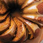 close up on the top of a pumpkin bundt cake with slices laying in their sides
