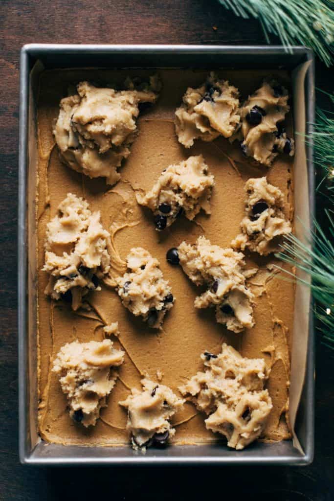 globs of cookie dough placed on top of gingerbread cookie dough