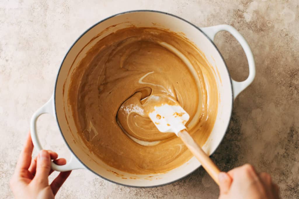 stirring a pot of melted butter, cookie butter, and marshmallow