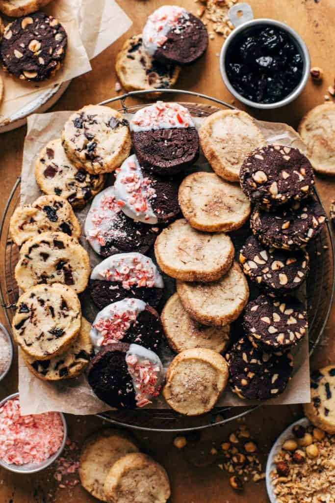 four different slice and bake cookies arranged on a wood serving tray