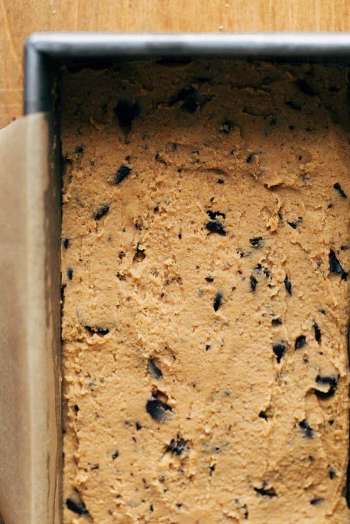 cookie dough spread into an even layer in a loaf pan