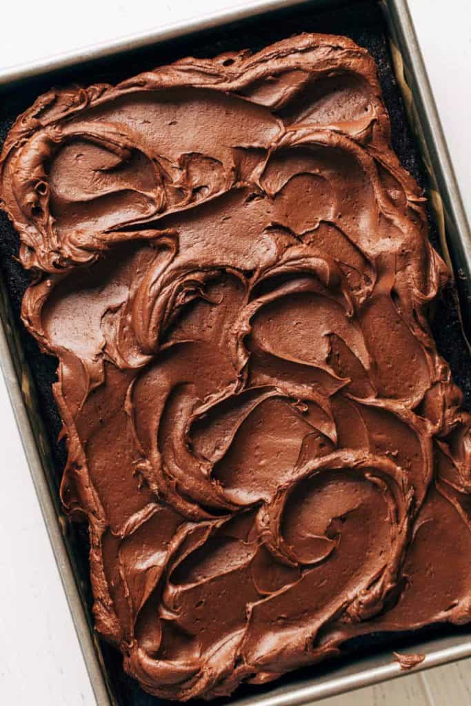 chocolate cream cheese frosting spread on a sheet cake