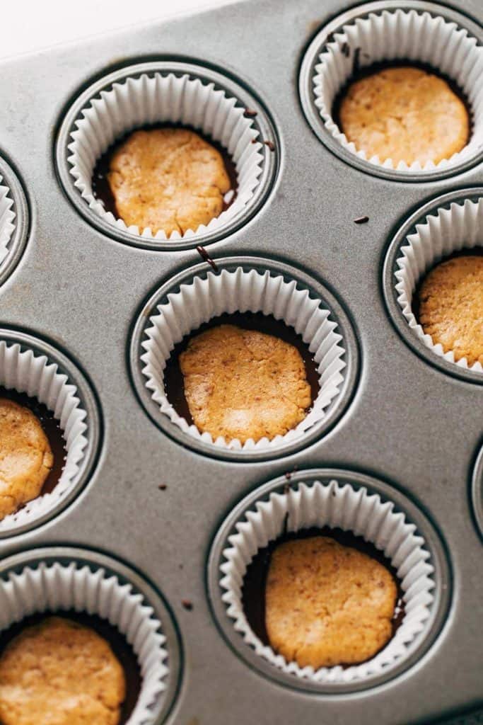 peanut butter placed in cupcake liners filled with chocolate