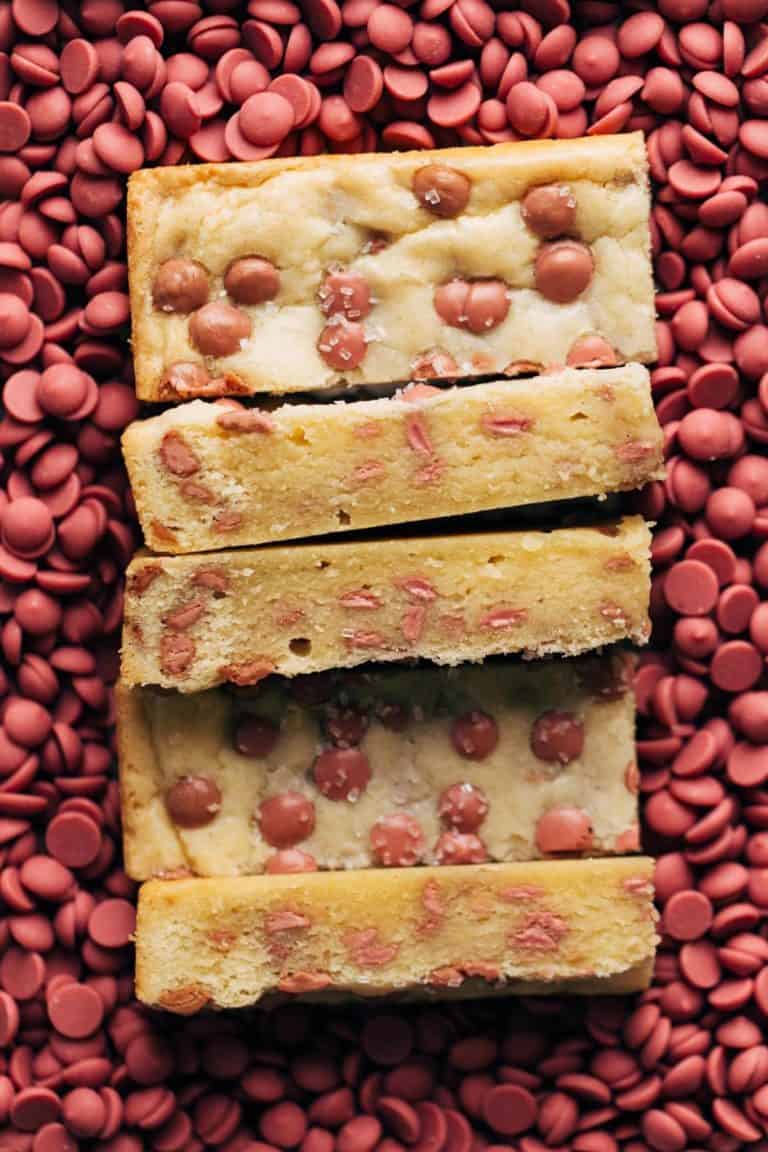 slices of shortbread resting in a bed of ruby chocolate chips