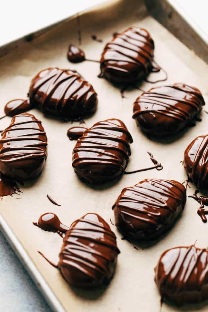 chocolate covered cookie dough eggs on parchment paper