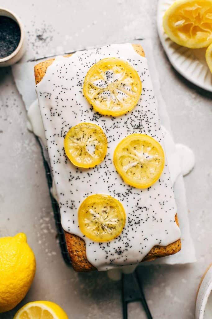 top view of a lemon poppy seed loaf with white icing and candied lemon slices.