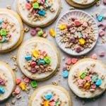 the top view of sugar cookies topped with frosting and Lucky Charms cereal