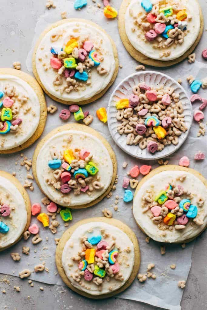 the top view of sugar cookies topped with frosting and Lucky Charms cereal