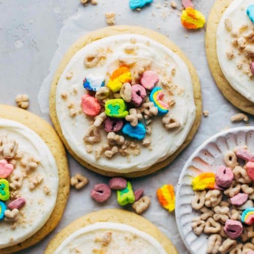 the top view of a sugar cookie topped with frosting and Lucky Charms cereal