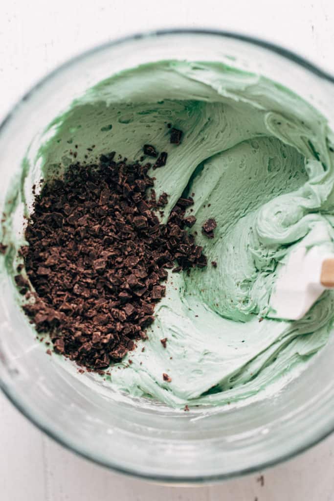 a bowl of mint chocolate chip frosting
