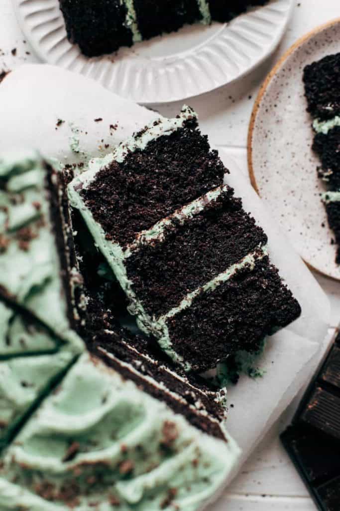 close up on a slice of mint chocolate chip layer cake