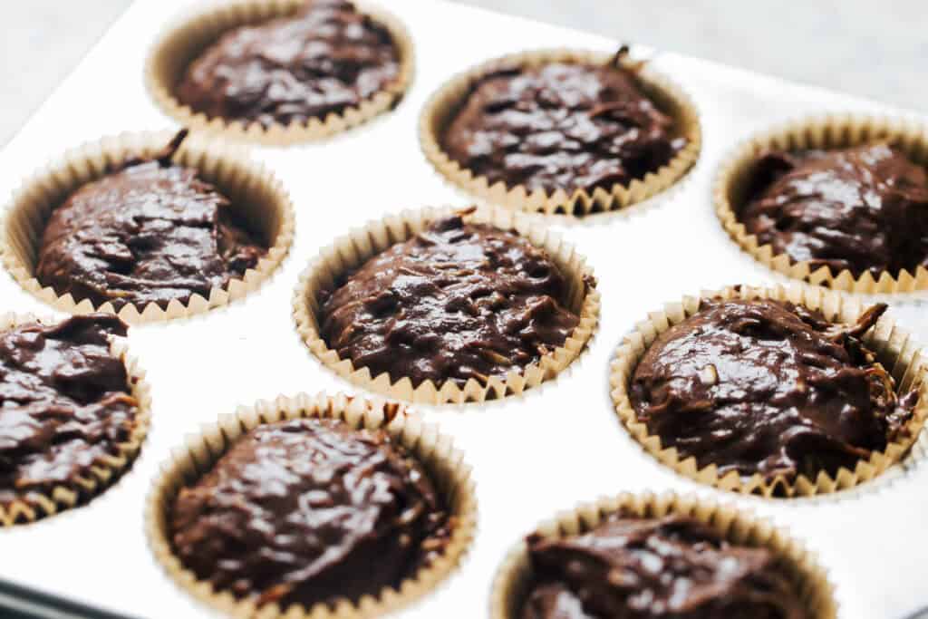 chocolate zucchini muffin batter in the tin