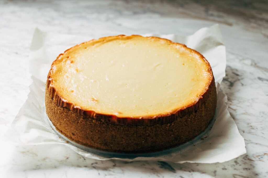 a freshly baked new york style cheesecake that has chilled overnight