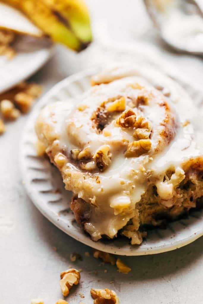 close up on a banana cinnamon roll on a plate