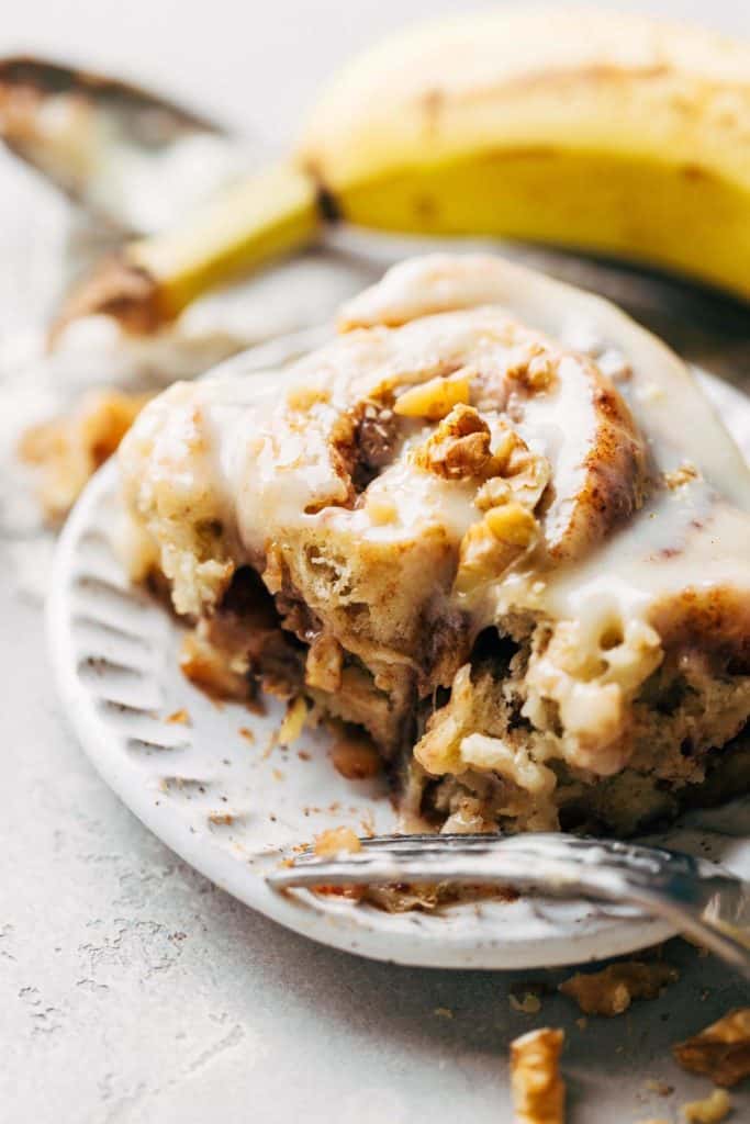 close up on a bite taken from a banana cinnamon roll