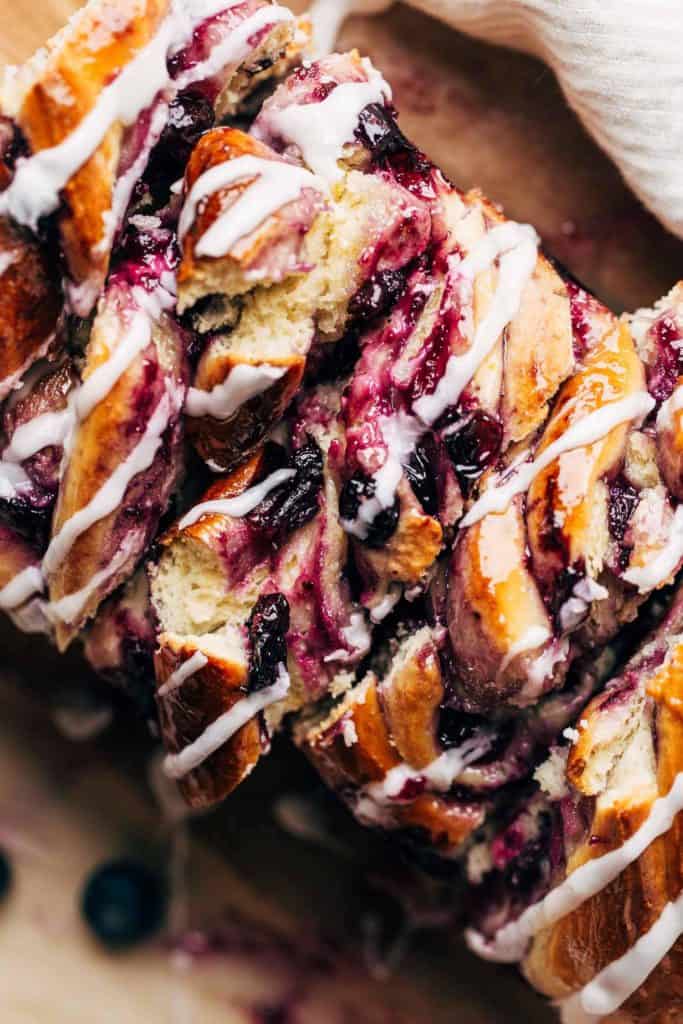 close up on the top of a sliced loaf of blueberry babka