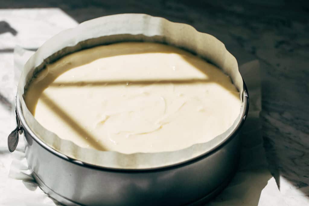 cheesecake batter in a baking pan