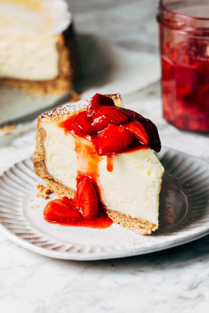 a slice of cheesecake with strawberry sauce on top