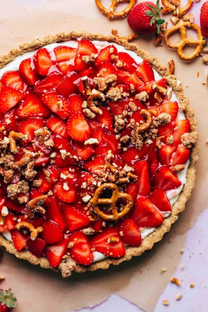 the top of a finished strawberry tart sprinkled with a pretzel crumble