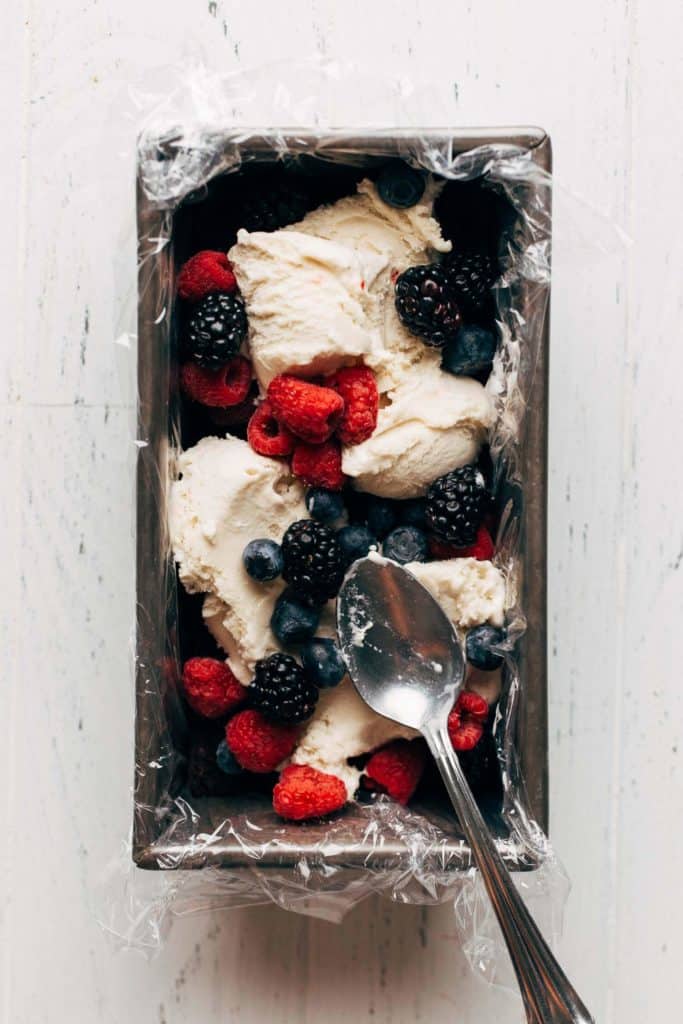 scoops of ice cream and fresh berries in a loaf pan