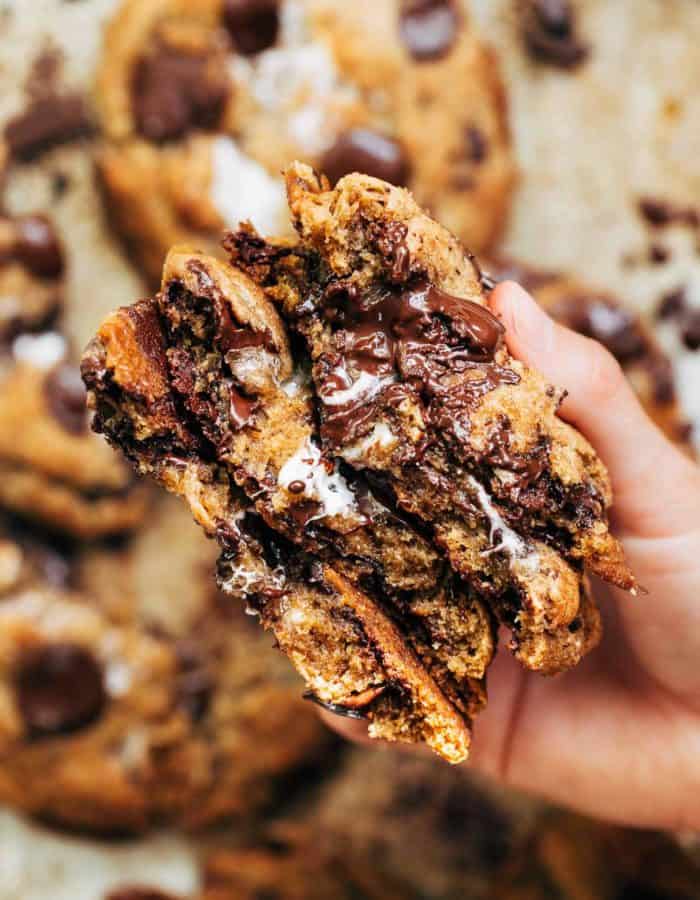 holding a stack of smores cookies split in half
