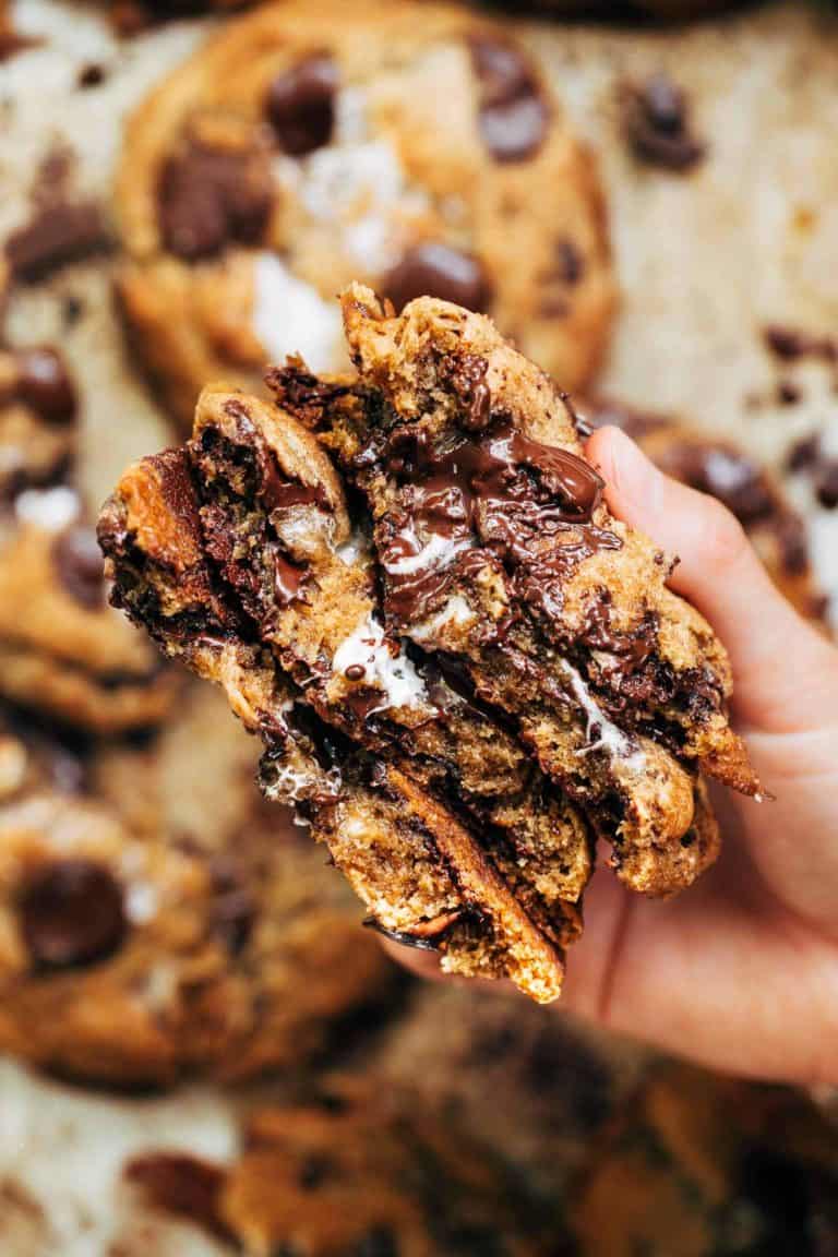 holding a stack of smores cookies split in half