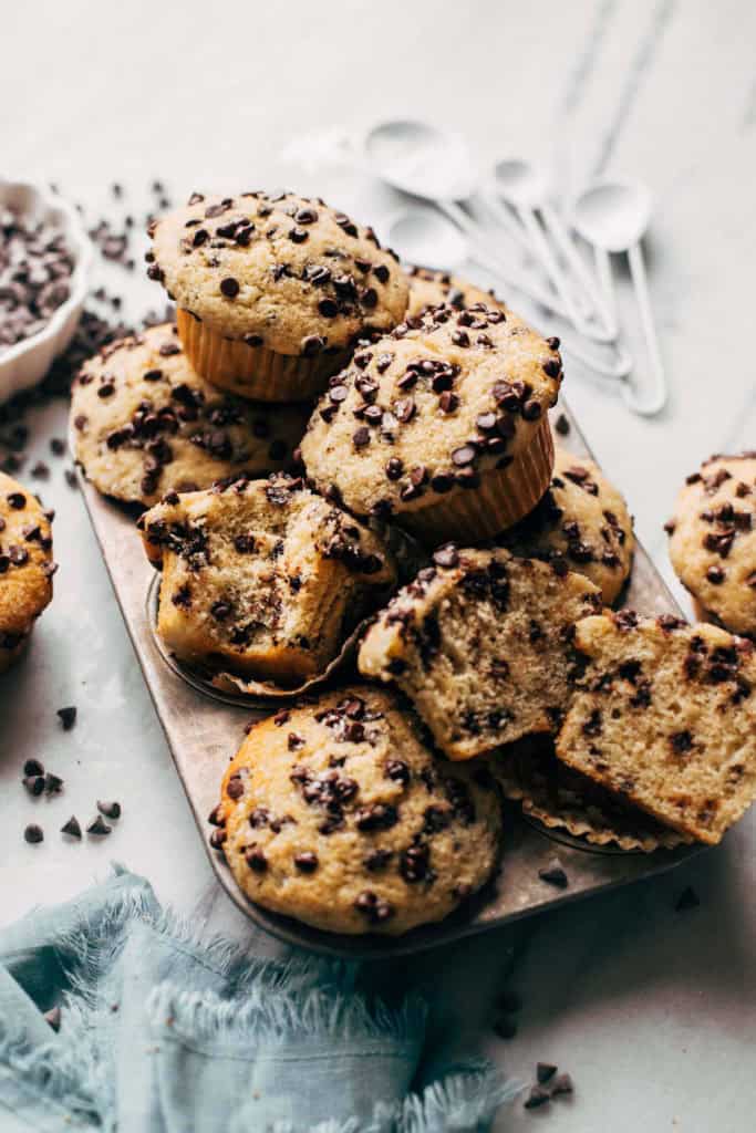 chocolate chip muffins stacked up on a muffin tin