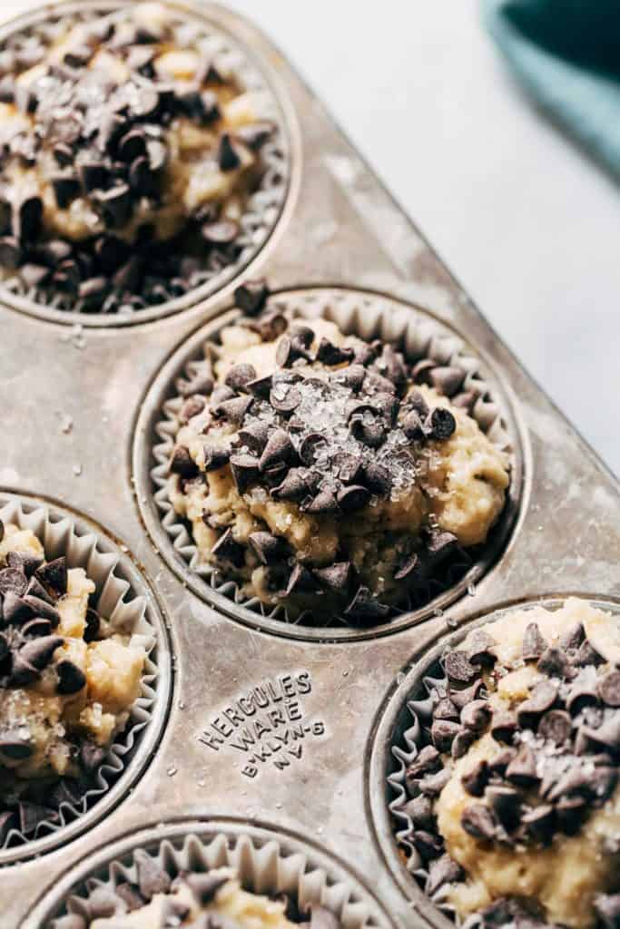 muffin batter scooped into liners and topped with chocolate chips