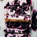 close up on slices of vegan blueberry cheesecake bars