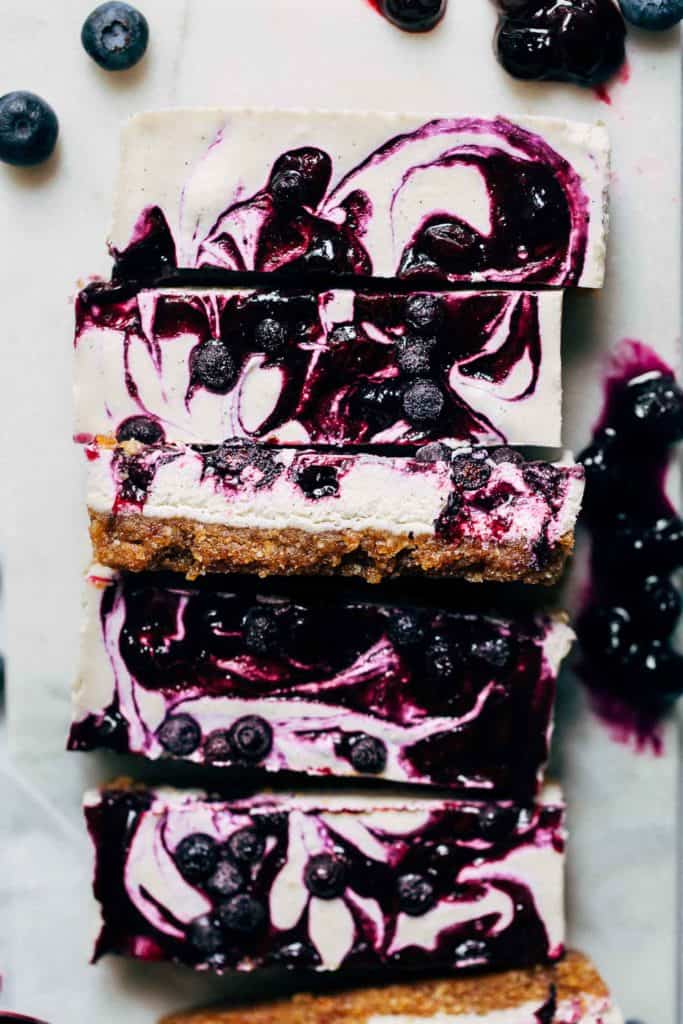 close up on slices of vegan blueberry cheesecake bars