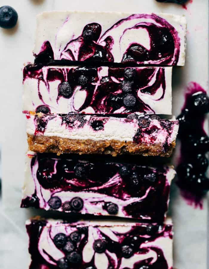 close up on slices of vegan blueberry cheesecake bars