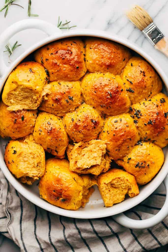 the tops of sweet potato rolls in a baking dish