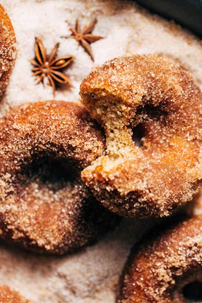 a bite taken from an apple cider donut