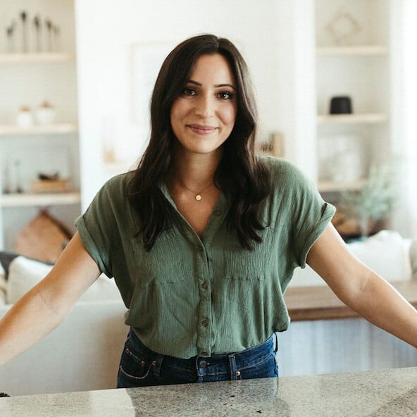 Jenna standing at a counter smiling