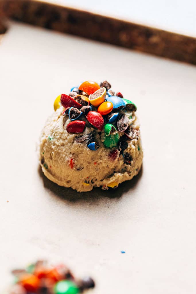 m&m cookie dough scooped on a baking tray