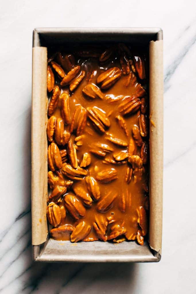 pecans tossed with caramel and spread on top of a layer of frozen cheesecake