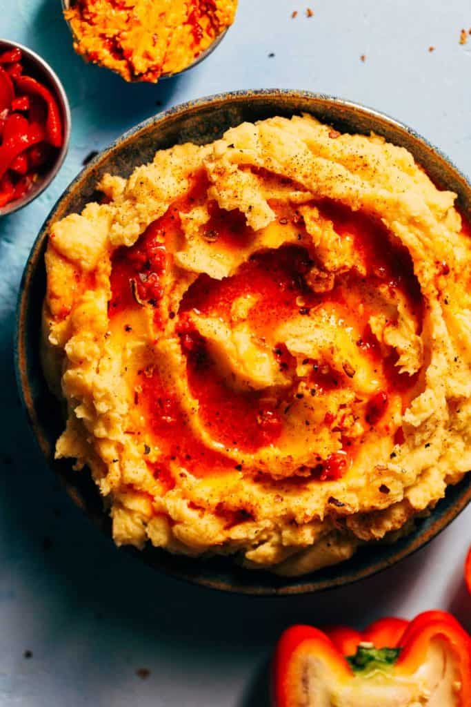 a bowl of pimento mashed potatoes topped with a pool of melted pimento butter