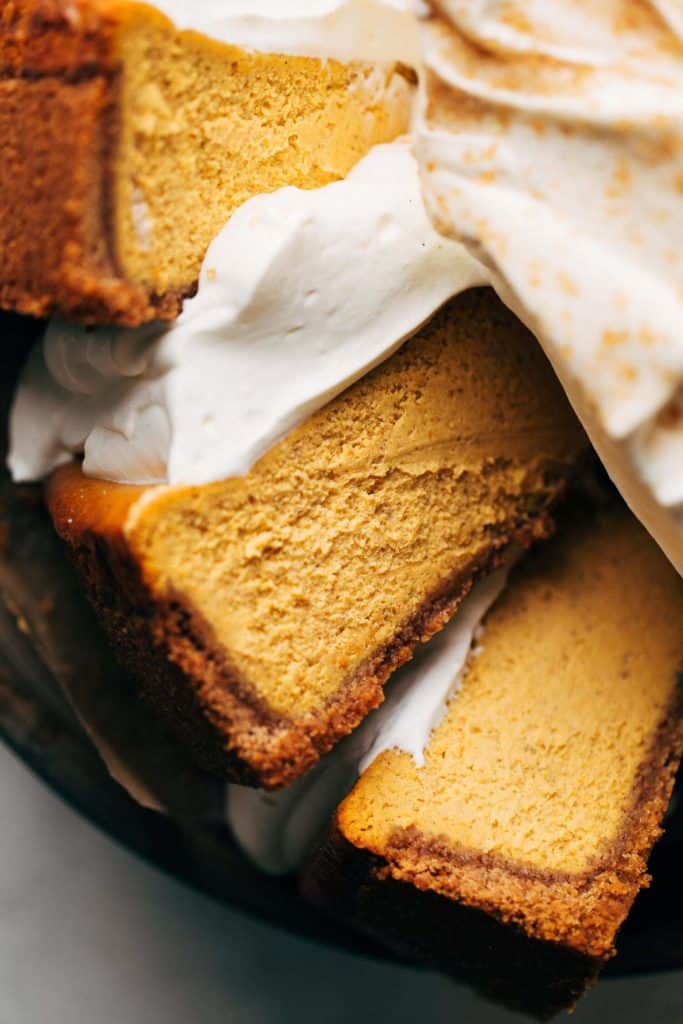 close up on a slice of pumpkin cheesecake laying on its side
