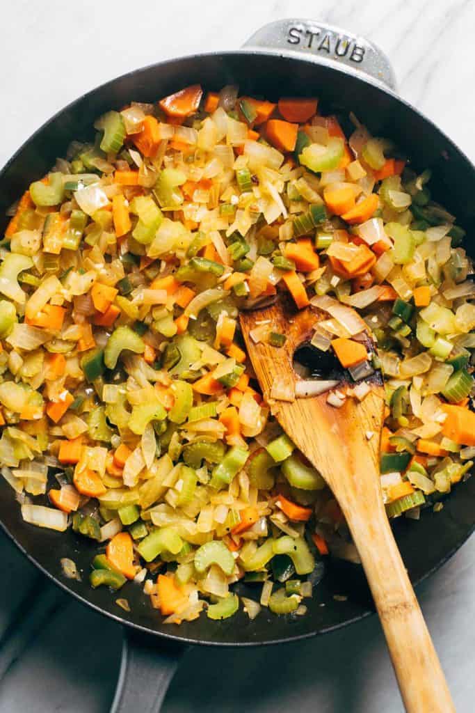 stuffing veggies stir fried in a pan
