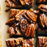 close up on the top of a vegan cheesecake bar topped with caramel pecans