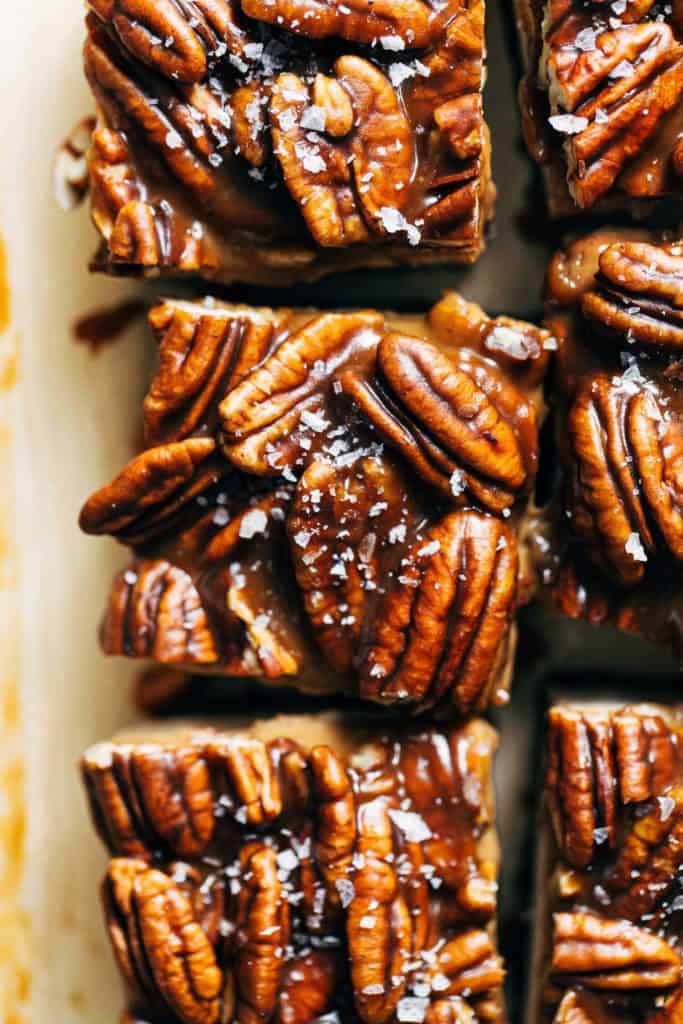 close up on the top of a vegan cheesecake bar topped with caramel pecans